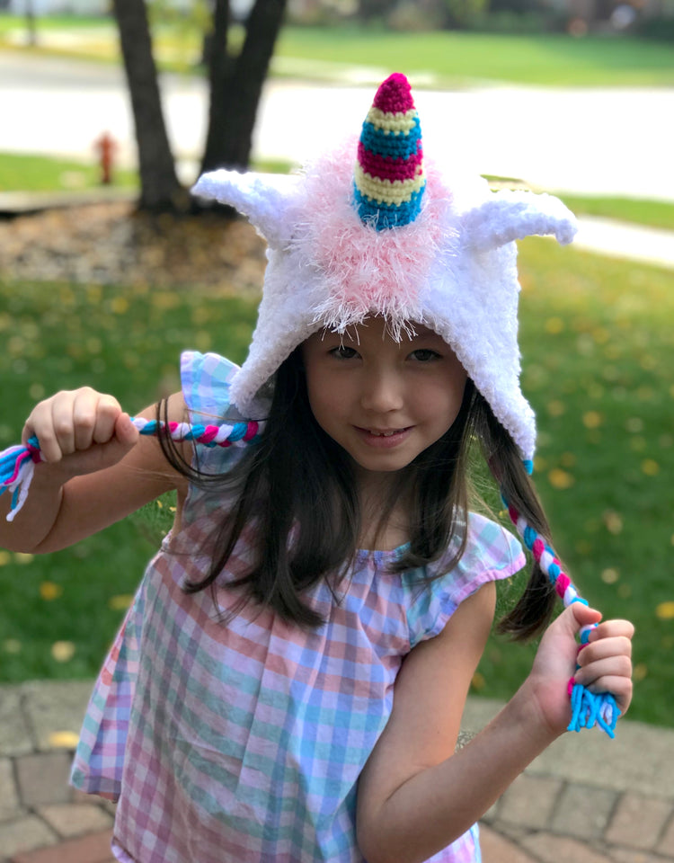 A girl wears sock monkey hat.